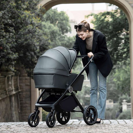 Woman with a Babymore Kai 3-in-1 Travel System in Forest Grey colour