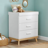 Angled photo of Babymore Mona Nursery Chest Changer in a corner of nursery room with teal-painted walls