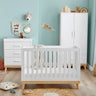 Babymore Mona Mini 3-Piece Nursery Room Set in a nursery with teal-colored walls
