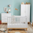 Babymore Mona Mini 3-Piece Nursery Room Set in a nursery with teal-colored walls