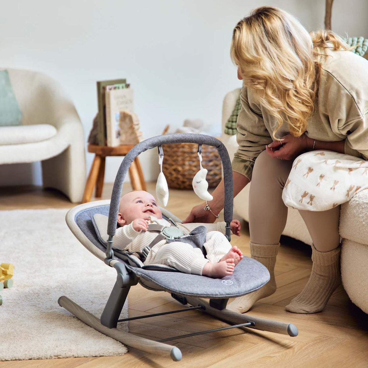 Baby lying safely in Ickle Bubba Stella Rocker in middle recline position