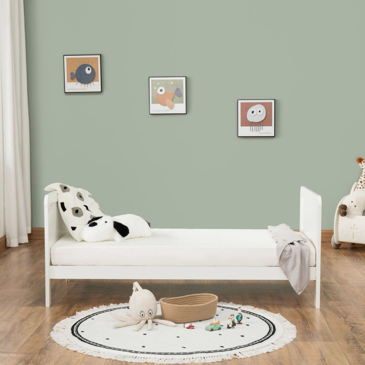 Front view of Babymore Caro Urban converted into toddler bed in a nursery room