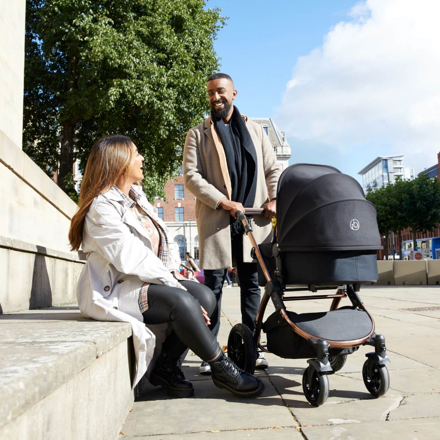 Smiling couple with Ickle Bubba Stomp Luxe 9-Piece Pram