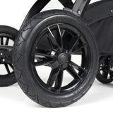 Close-up shot of all-terrain wheels in Ickle Bubba Stomp Luxe Pushchair in Woodland green colour with bronze chassis and tan handle