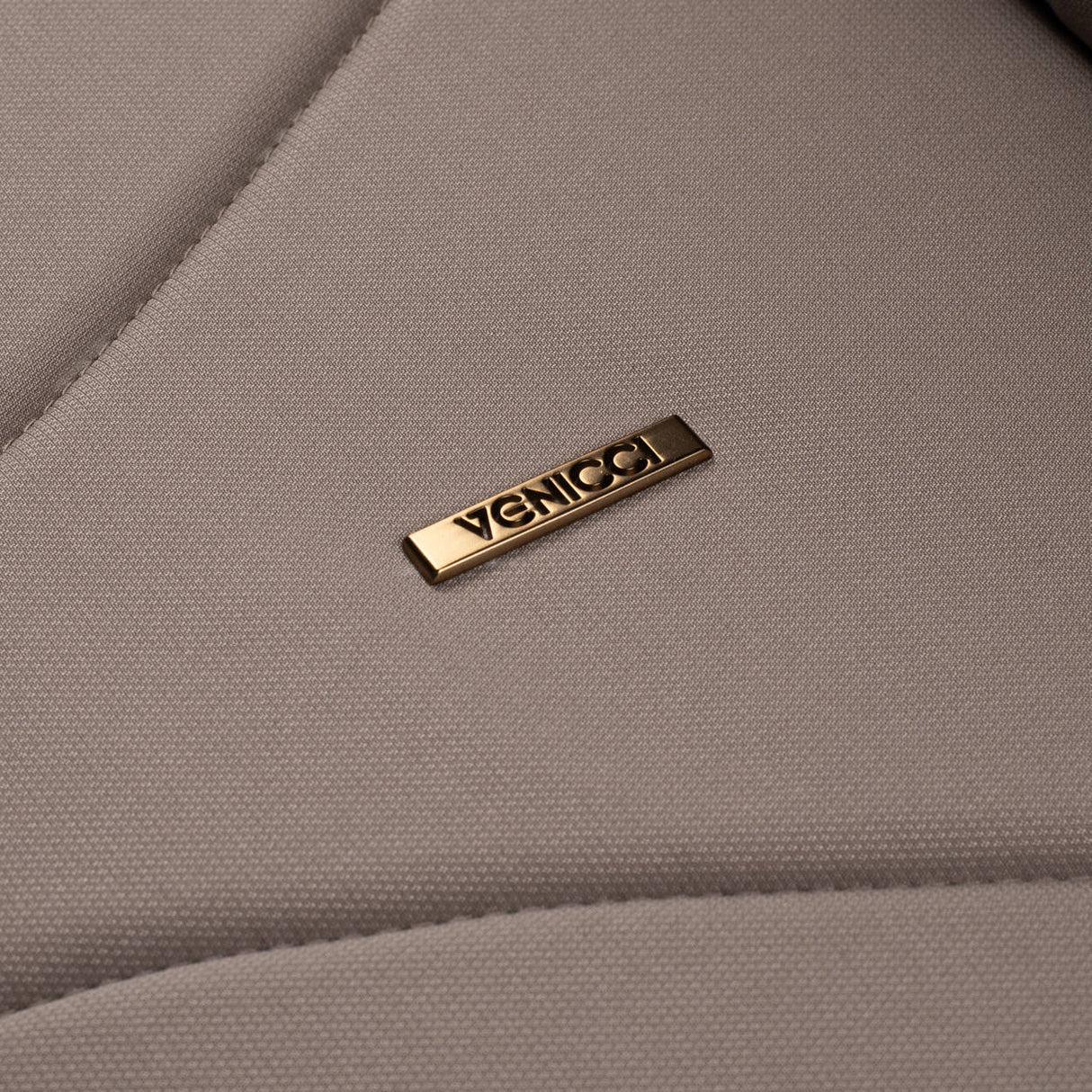 Close-up shot of Venicci logo in Claro carrycot in Almond colour
