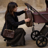 Woman opening the backpack included in Venicci Upline 2 Special Edition (SE) Pushchair and Travel System bundles